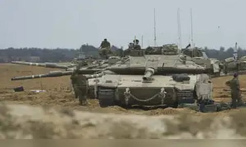 Israeli soldiers work on tanks and APCs at a staging area near the border with the Gaza Strip, in southern Israel, Thursday, May 15, 2025. (AP)