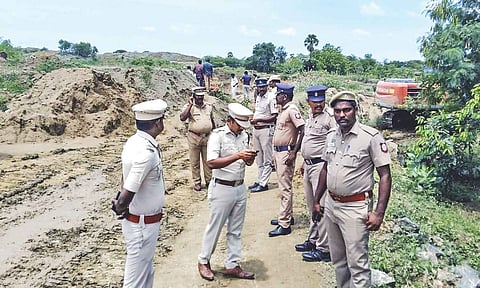 Police personnel stand near the stone quarry in Mallakottai 