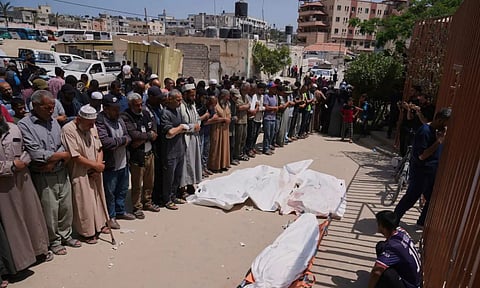 Palestinians pray at funeral of a person who was killed while heading to the Gaza aid hub (AP)