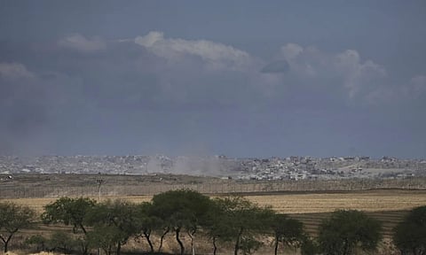 Smoke from Israeli bombardment rises over buildings in the northern Gaza Strip, seen from southern Israel (AP)