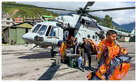 NDRF personnel and others during a rescue operation of stranded tourists stuck after multiple landslides triggered by heavy rain, in Mangan district, Sikkim (PTI)
