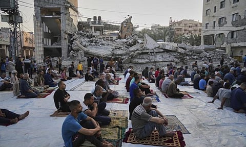 Palestinians gather for Eid al-Adha prayers beside the ruins of a mosque destroyed by Israeli bombardment, in Deir al-Balah, Gaza on Friday, June 6, 2025 (AP)