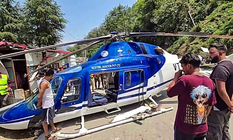 Damaged tail boom of a Kedarnath Dham-bound helicopter lies atop a car after it made an emergency landing at Badasu area, in Rudraprayag district, Uttarakhand, Saturday, June 7, 2025 (PTI)