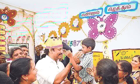 School Education Minister Anbil Mahesh Poyyamozhi with students at an Ennum Ezhuthum centre (file photo)