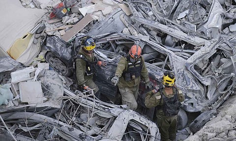 Israeli soldiers dig through rubble to search for survivors in a residential area hit by a missile fired from Iran, near Tel Aviv, Israel. (AP Photo)