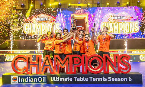 U Mumba TT players celebrate with the trophy