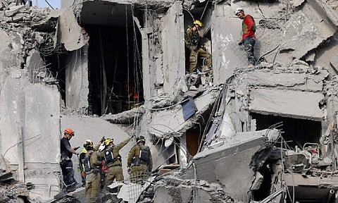 Israeli soldiers search for survivors amid the rubble of residential buildings (Photo: AFP) 