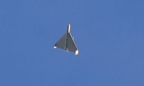 An Iranian Shahed exploding drone launched by Russia flies through the sky seconds before it struck buildings in Kyiv (AP)