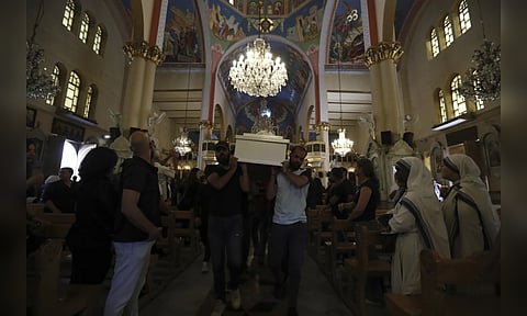 Pallbearers carry the coffin of a victim of suicide bombing at Mar Elias Greek Orthodox Church (Photo: AP)