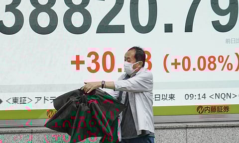 A person walks in front of an electronic stock board showing Japan's Nikkei index at a securities firm Wednesday, June 25, 2025, in Tokyo (AP) 