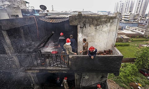 Firefighters carry a victim's body after a fire broke out in a chemical factory, at Rithala, in New Delhi, Wednesday, June 25, 2025. At least four people were killed in the incident (PTI)