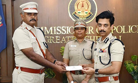 ACP (Vepery) R Kannan receives a certificate of appreciation from Commissioner A Arun. Also seen is DCP (Kilpauk) J Jareena Begam 