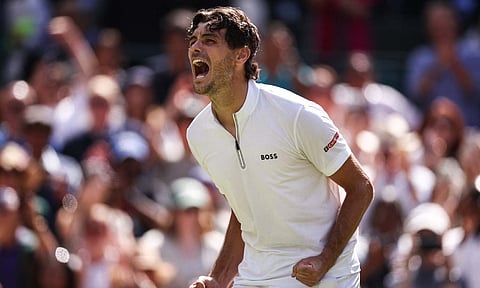 Taylor Fritz lets out a roar after his victory
