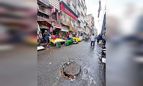 Broken and partially open manhole on busy Mint Street posing a threat