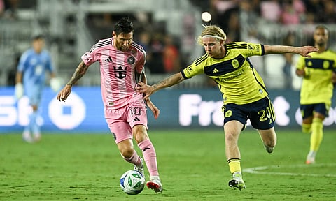 Lionel Messi dribbles past Edvard Tagseth 