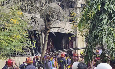 Firemen check the wreckage of a Bangladesh Air Force training aircraft that crashed onto a school campus in Dhaka, Bangladesh, Monday, July 21, 2025 (AP) 