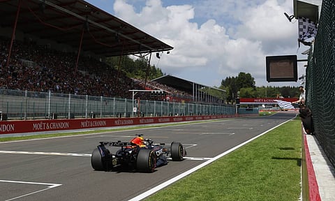 The checkered flag goes out as Red Bull driver Max Verstappen of the Netherlands crosses the finish line to take first place during the sprint race ahead of the Formula One Grand Prix at the Spa-Francorchamps racetrack in Spa, Belgium, Saturday, July 26, 2025 (AP) 