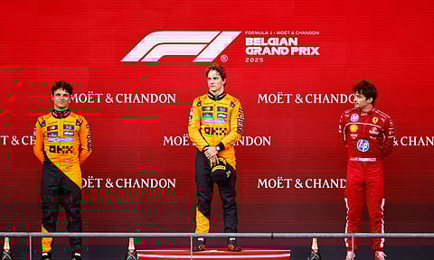 McLaren’s Oscar Piastri (centre) stands on the podium with second placed McLaren’s Lando Norris and third placed Ferrari’s Charles Leclerc after the Formula One Belgian Grand Prix