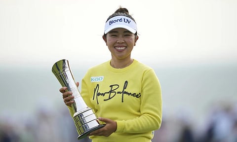 Miyu Yamashita of Japan poses with her trophy after winning the Women's British Open golf championship, at Royal Porthcawl Golf Club in Porthcawl, Wales, Sunday, Aug. 3, 2025 (AP) 