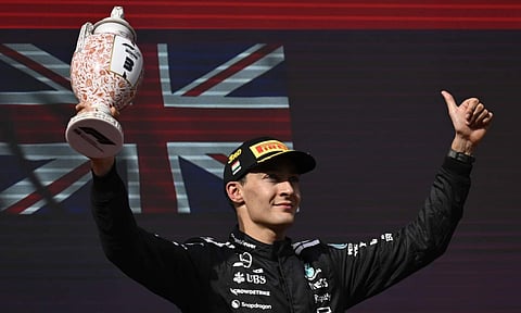 Mercedes driver George Russell of Britain celebrates his third place after the Hungarian Formula One Grand Prix race at the Hungaroring racetrack in Mogyorod, Hungary, Sunday, Aug. 3, 2025 (PTI) 