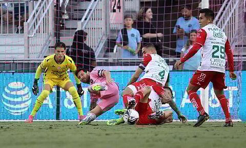  Lionel Messi tackled by defenders during the match