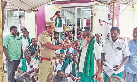 A section of the farmers protesting against the alleged usurping of temple land, at the RDO office in Thanjavur on Friday