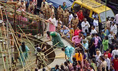 Members of the Jain community attempt to remove the covers placed on a 'kabutarkhana' by BMC to restrict pigeon feeding, at Dadar (PTI)