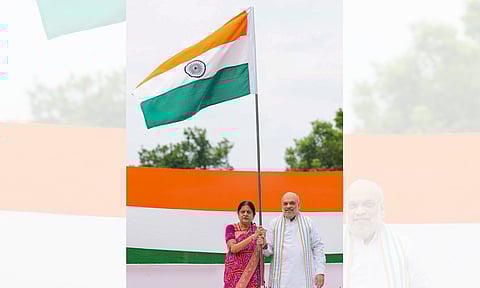 Union Home Minister Amit Shah with his wife Sonal Shah hoists the tricolour as part of the 'Har Ghar Tiranga' campaign ahead of Independence Day celebrations, at his residence in New Delhi (PTI)