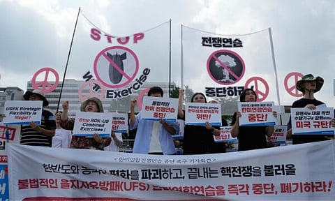 South Korean protesters stage a rally to oppose the joint military exercises, Ulchi Freedom Shield or UFS, between the U.S. and South Korea in front of the presidential office in Seoul, South Korea, Monday, Aug. 18, 2025. The banners read "Stop the military exercise between the U.S. and South Korea." (AP)