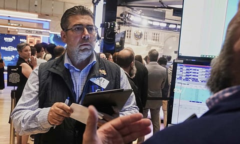 Trader Michael Capolino left, works on the floor of the New York Stock Exchange, Monday, Aug. 18, 2025 (AP) 