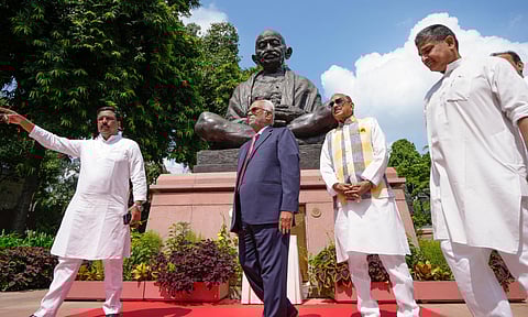 INDIA bloc's vice presidential candidate B Sudershan Reddy pays floral tribute to the statue of social reformer Jyotiba Phule, before filing his nomination, during a visit to the Parliament House complex, in New Delhi, Thursday, Aug. 21, 2025 (PTI) 