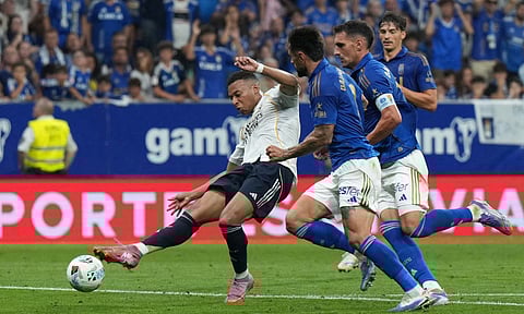 Kylian Mbappe takes a shot to score Madrid's opener 