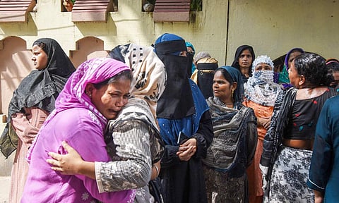 Family members of the 12-year-old girl who died on Wednesday, mourn, after she was found with severe burn injuries inside the washroom of a government-run school, in Patna, Thursday, Aug. 28, 2025 (PTI) 