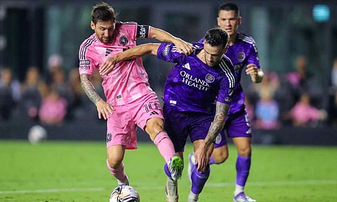 Lionel Messi dribbles past David Brekalo in the match 