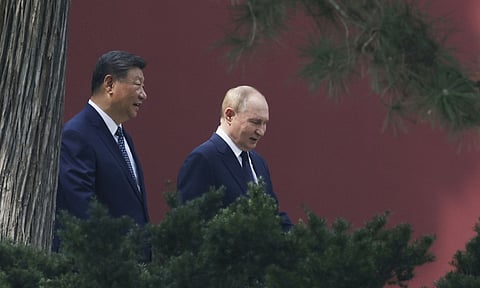Russian President Vladimir Putin speaks with Chinese President Xi Jinping (AP)
