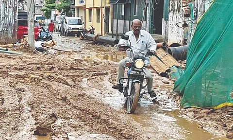Man driving through a muddy patch of road in Alandur