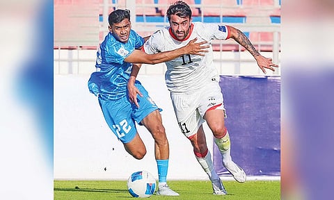 Ashique Kuruniyan fights for the ball with a Afghan player 