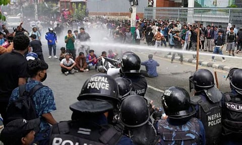 Riot police use water cannon on protesters during clashes outside parliament building in Kathmandu, Nepal (AP Photo)