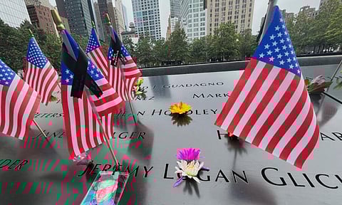 Flags and flowers are placed in the inscribed names at the National September 11 Memorial in New York (AP)