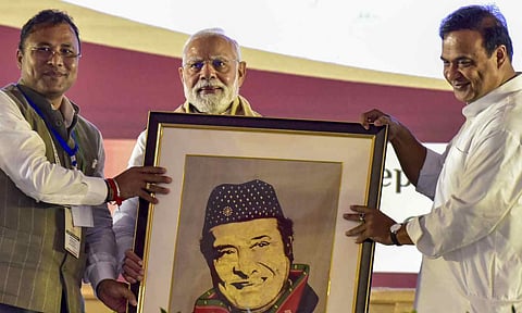Prime Minister Narendra Modi being felicitated with a portrait of legendary singer and Bharat Ratna awardee Bhupen Hazarika by Assam Chief Minister Himanta Biswa Sarma and others during a programme organised on the occasion of the singer's birth centenary celebration, in Guwahati, Assam (PTI) 