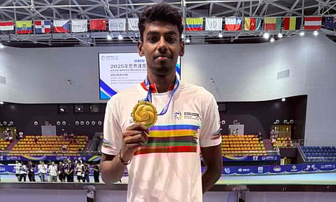 Anandkumar Velkumar poses with his medal 