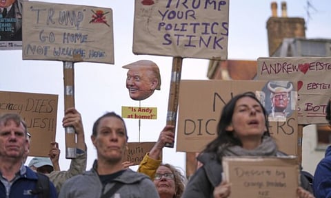 People show placards at a protest of the Stop Trump Coalition group against President Donald Trump's state visit in London (AP)
