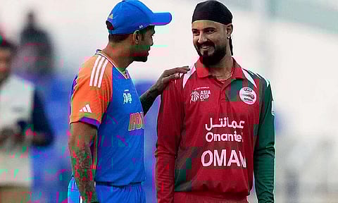 India's captain Suryakumar Yadav, left, talks with Oman's Captain Jatinder Singh before the toss for their Asia Cup 2025 clash in Abu Dhabi. Photo: AP