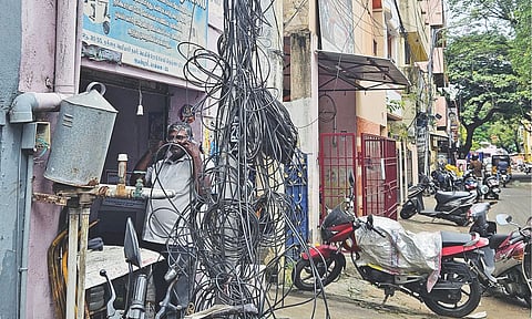 Internet cables tangled on an electric post at Thanthai Periyar Nagar 1st Street in Ayanawaram