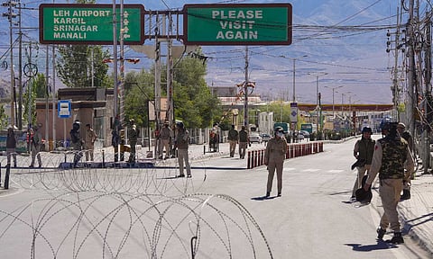 ecurity personnel stand guard on a road amid curfew, days after violence during protests for Ladakh statehood