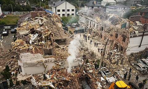 Rescuers work at the site of an apartment buildings damaged during a Russian attack in Kyiv (AP)