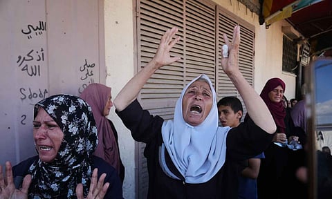 Palestinians mourn during the funeral of their relatives (AP)