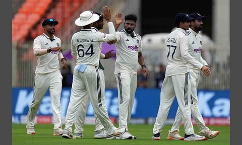 India's Mohammed Siraj, center, celebrates with teammates after the dismissal of West Indies' Tagenarine Chanderpaul on the first day of the first Test cricket match between India and West Indies at Narendra Modi Stadium in Ahmedabad (PTI) 