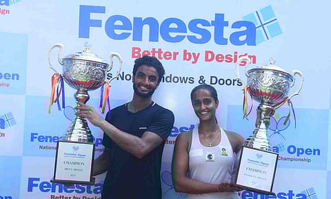 Manish Sureshkumar and Vaishnavi Adkar pose with the trophies 