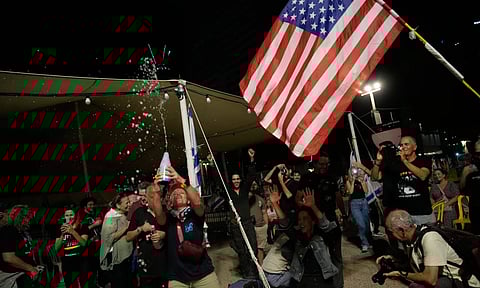 People react as they celebrate following the announcement that Israel and Hamas have agreed to the first phase of a peace plan 